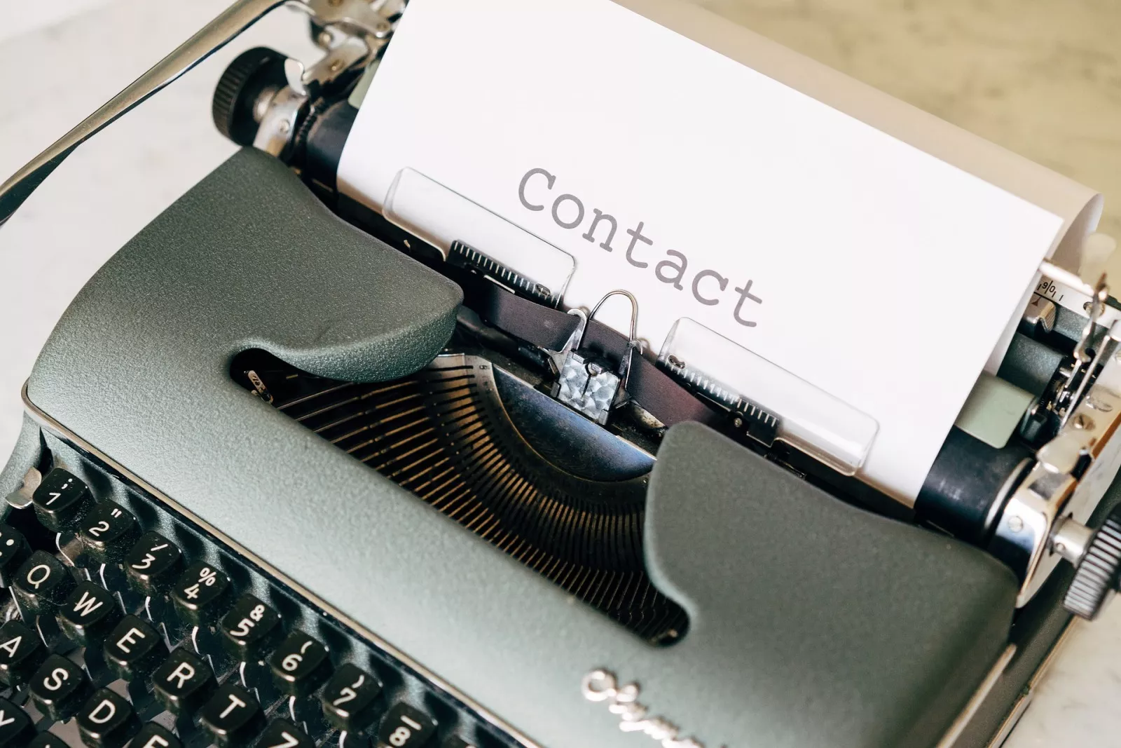 Contact page - typewriter with a paper that contains the word contact